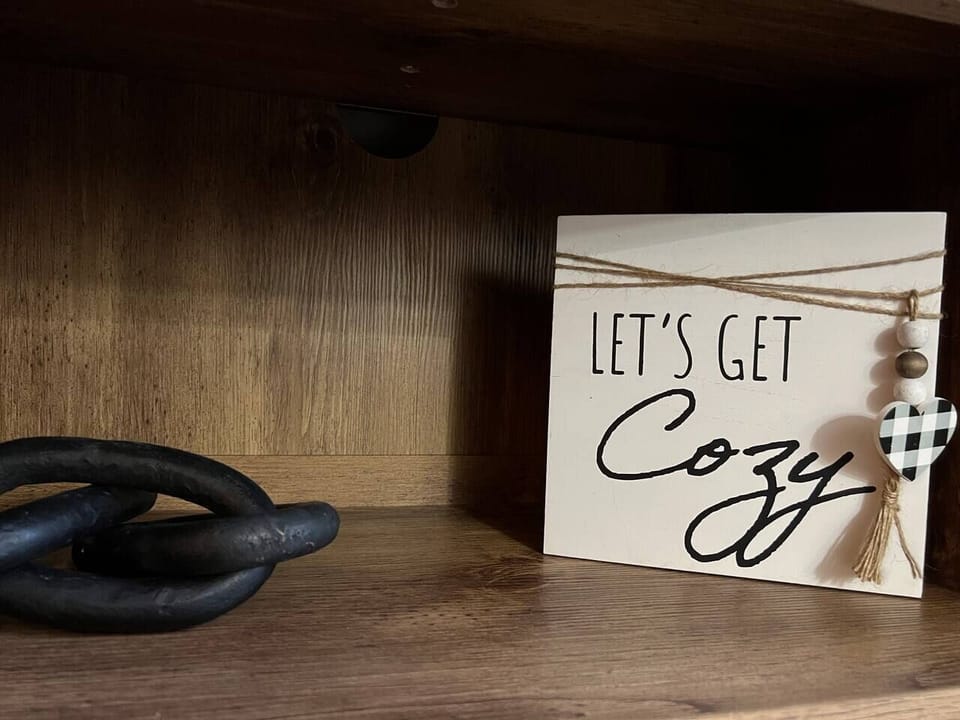 Our whimsical 'let's get cozy' sign sets the mood for snuggles, laughter, and all-around comfort.