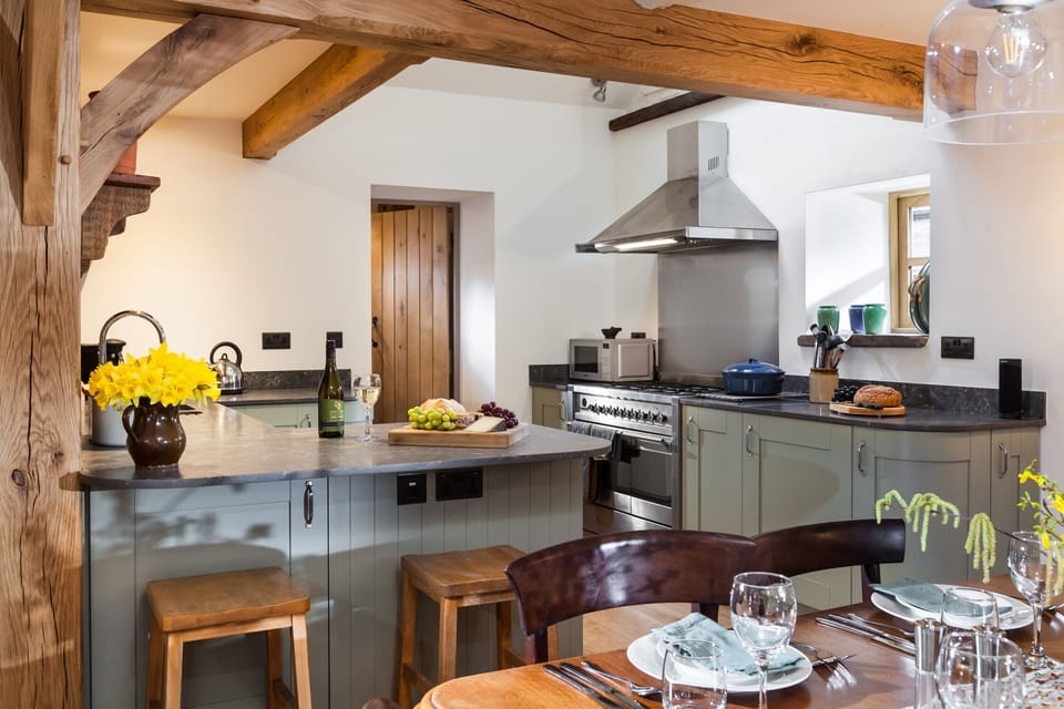 The dining area leading through to the kitchen with exposed beams