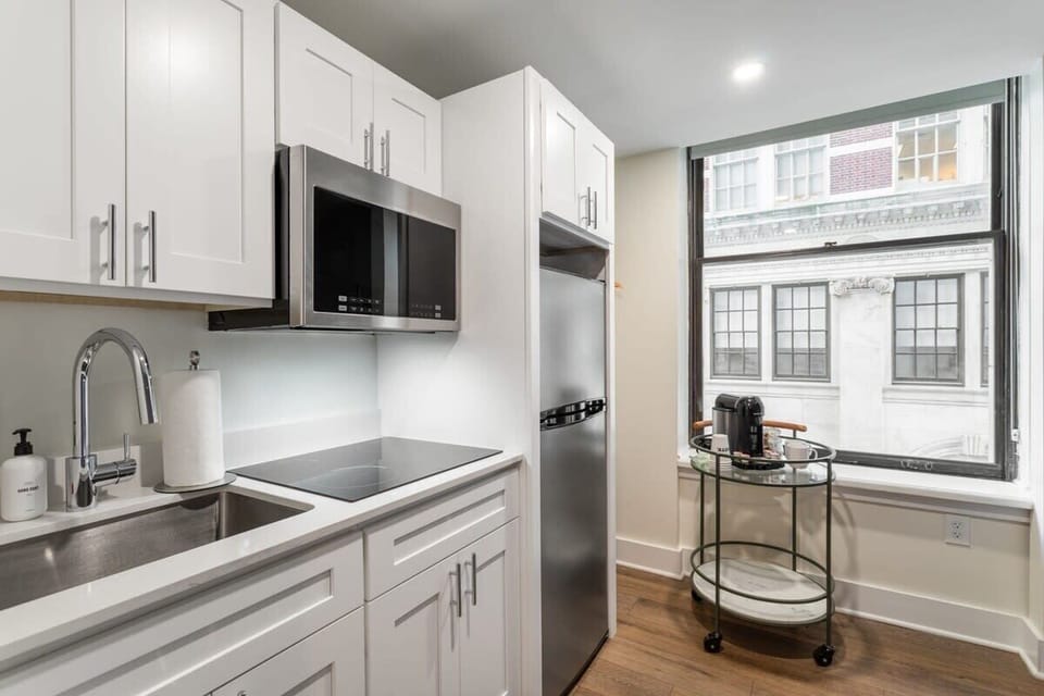 Enjoy making home-cooked meals or getting take out in this lovely kitchen with stainless steel and full-size refrigerator.