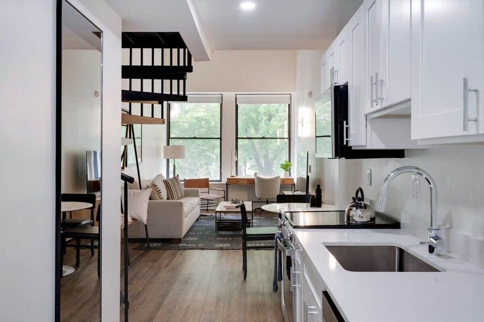 Bright and cozy living area with huge flat screen TV
