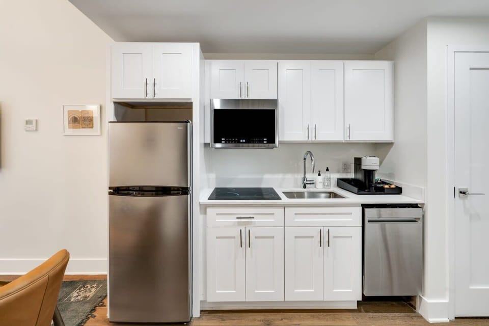 Enjoy making home-cooked meals or getting takeout in this lovely kitchen with stainless steel appliances and a full-size refrigerator