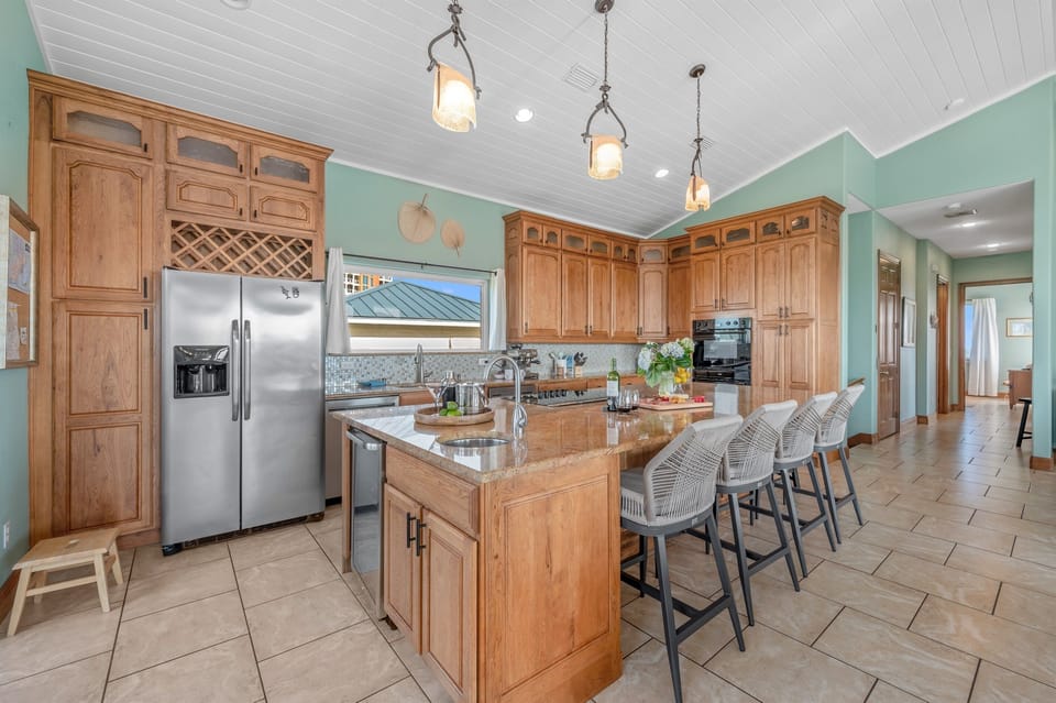 Savor Meals at the Expansive Granite Kitchen Island or Gather Around the Dining Room Table. Pull up to 7 Bar Stools for Casual Conversations.