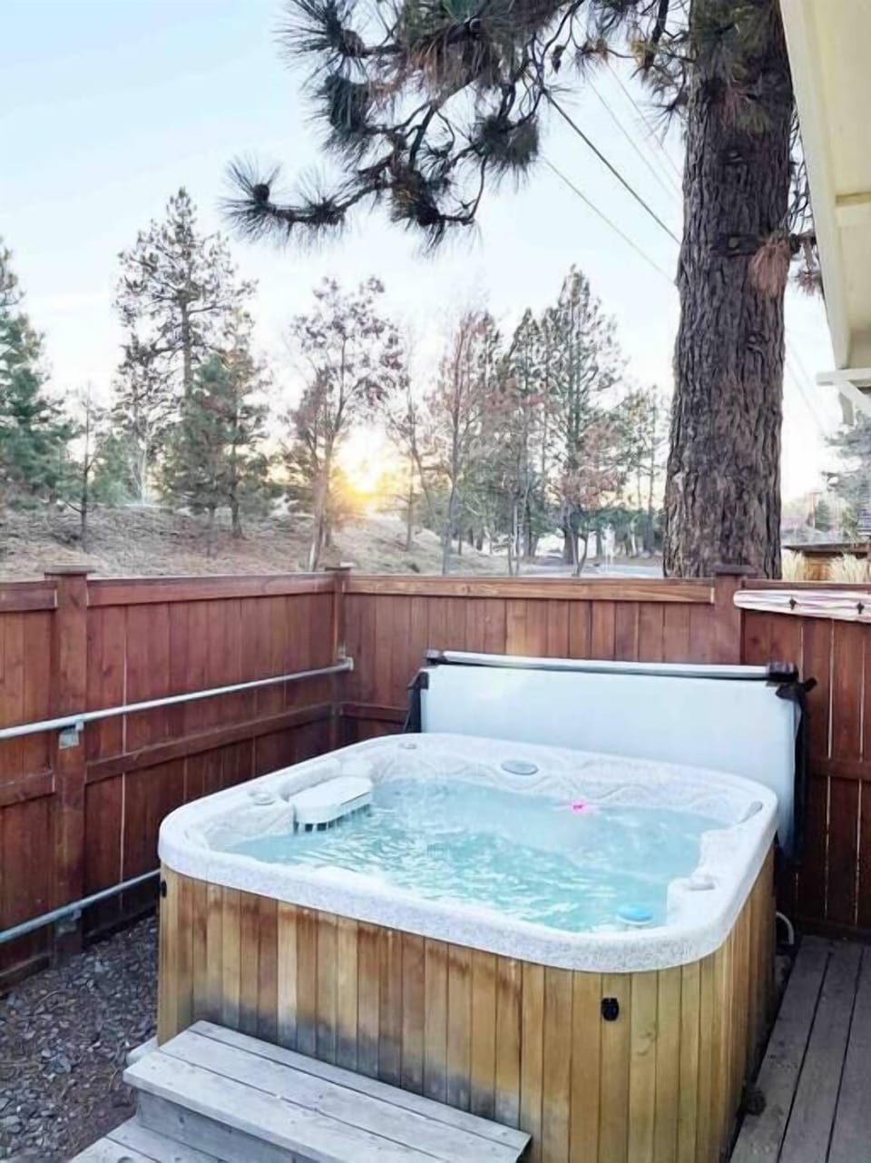 The hot tub is located just behind the boat house. 