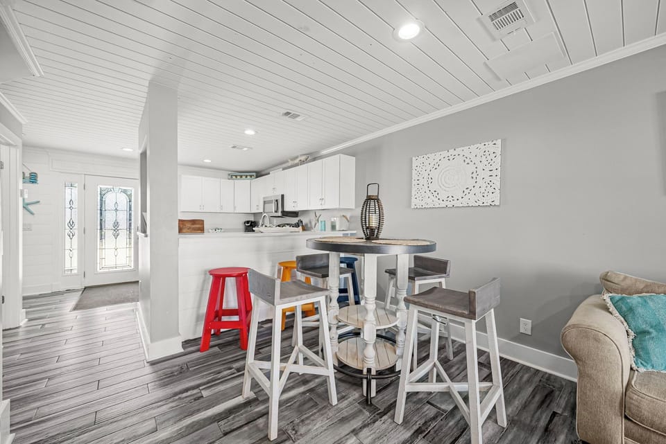 modern dining area with a round table and mixed seating in an open kitchen layout