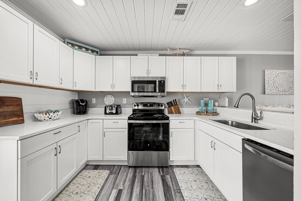 Modern kitchen with stainless steel appliances and white cabinetry