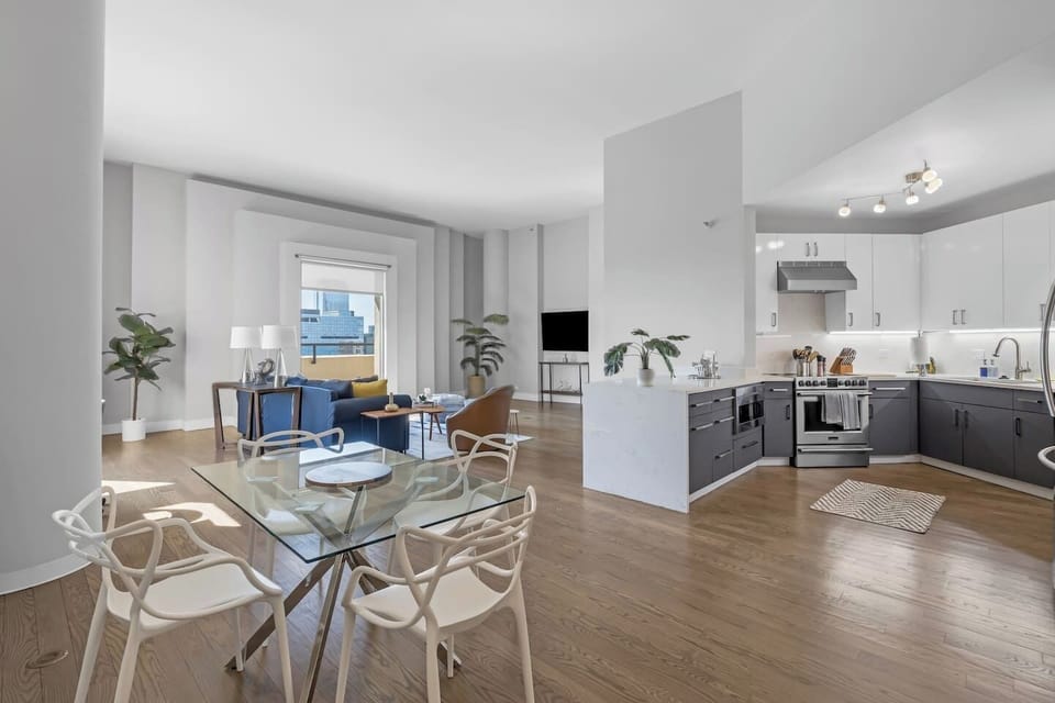 Here is the upstairs dining area, full cook`s kitchen, living room equipped with a sleeper sofa and 55` Smart TV, a half bath, and the private outdoor patio.