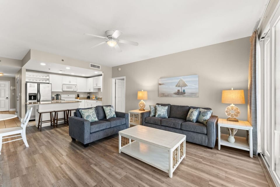 Ocean View Living Area with Sleeper Sofa, TV, Dining Table and Private Balcony Access