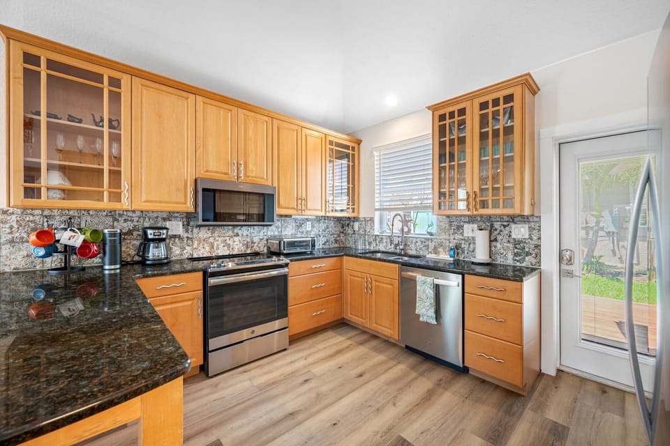 Kitchen with sleek appliances, granite countertops, and plenty of cabinet space