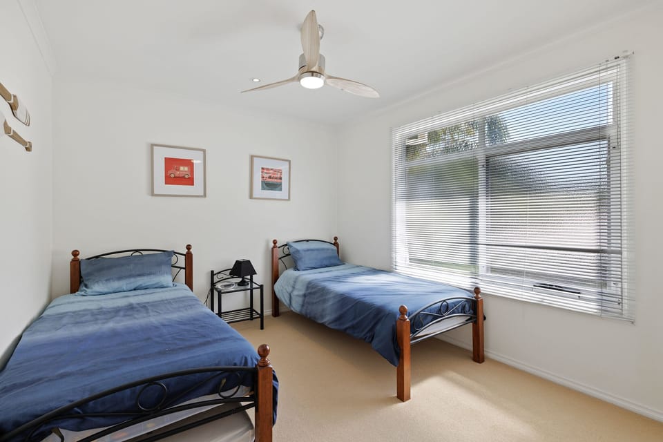 Light and bright bedroom with two single size beds. Located upstairs
