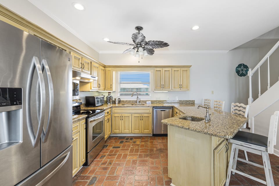 Large wrap-around countertop with extra sink and additional seating