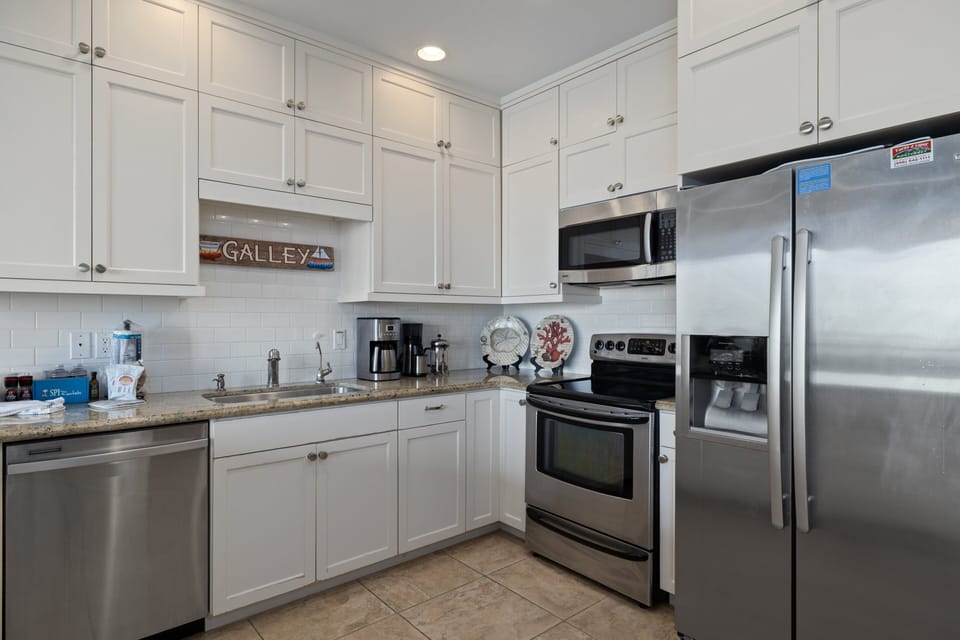 Fully equipped kitchen area with pots, pans, and dishware essential for cooking your favorite meals