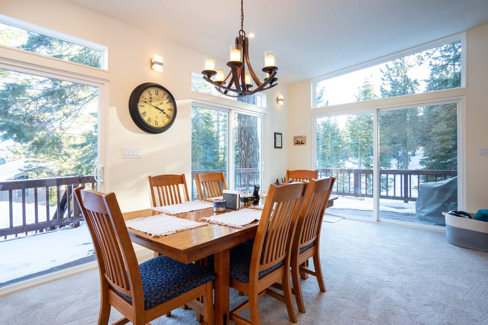 The bright and open space, highlighted by large sliding glass doors, creates a seamless flow from the kitchen to the dining area, effortlessly blending indoor and outdoor living