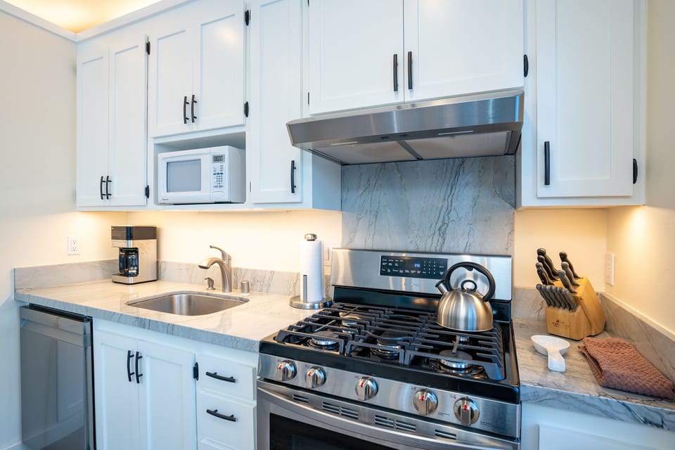 Enjoy a fully stocked kitchen featuring sleek stainless steel appliances, perfect for preparing meals with ease