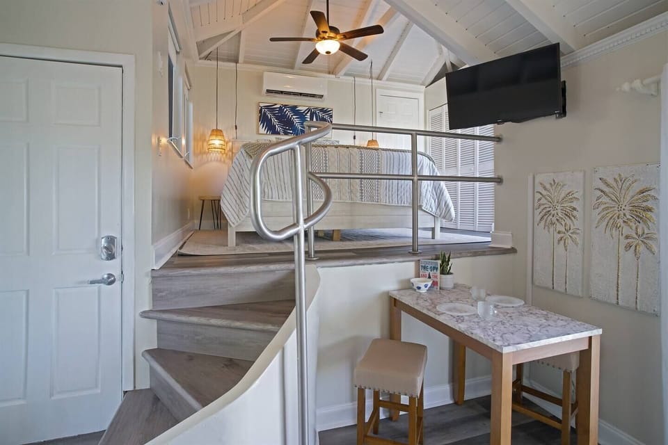 Small dining area with the loft style bedroom a few steps up