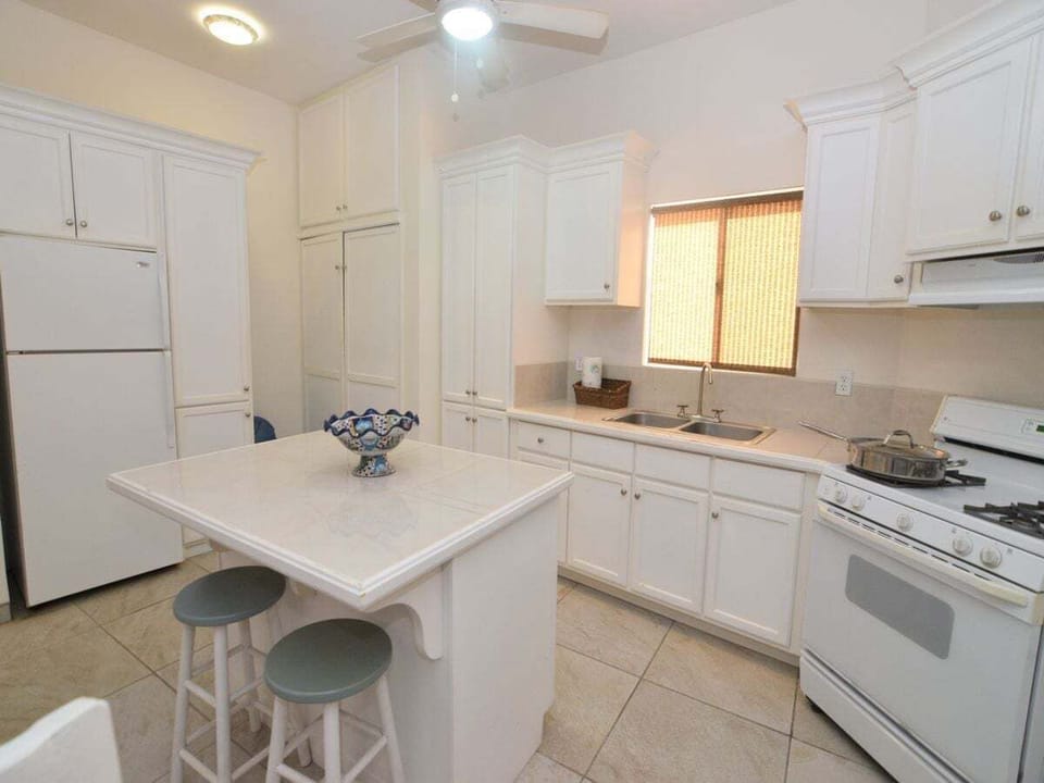 The kitchen area at Casa Sunny Side includes a dining table with seating — perfect for quick meals or morning coffee before heading out .