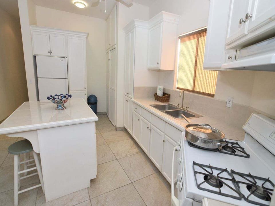 The kitchen at Casa Sunny Side is inspired by authentic Mexican design and extends into a cozy dining area with a table and seating for four — a casual space for breakfast or planning the day's adventures