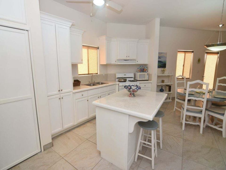 The gorgeous kitchen at Casa Sunny Side is inspired by authentic Mexican design and includes a full-size refrigerator, oven, microwave, coffee/tea maker, and essential cookware