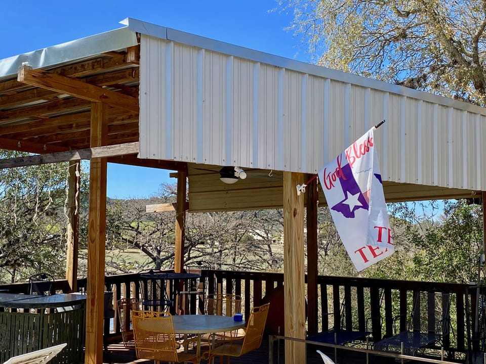 Trulove Lodge - Covered bar and seating on deck overlooking the river.