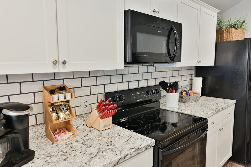 Stylish subway tiled backsplash behind the kitchen counter.