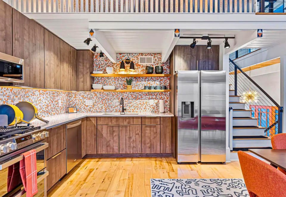 Vibrant and Colorful Accents Compliment the Wood Cabinets and Stainless Steel Appliances