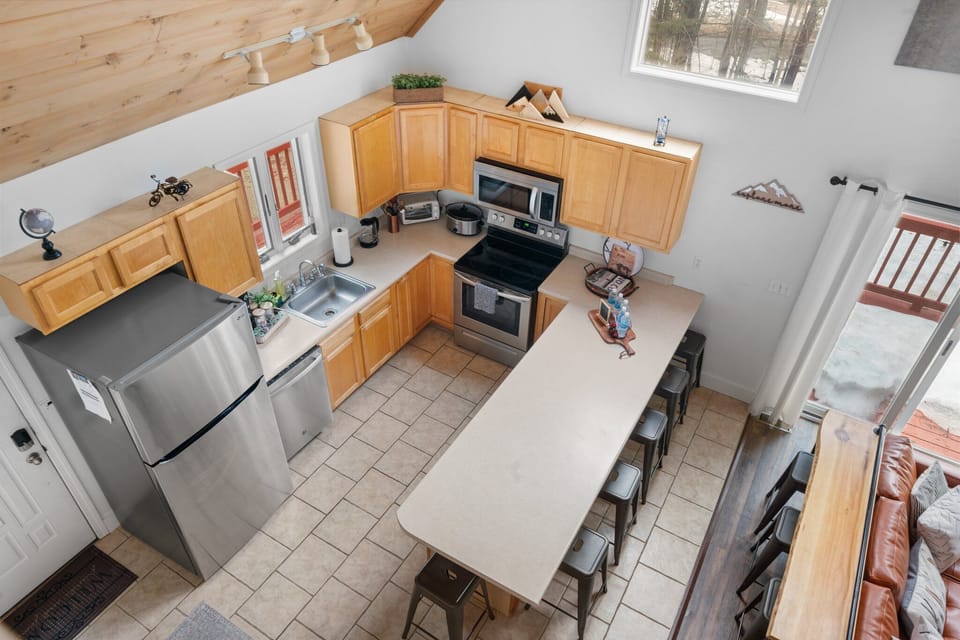 A kitchen with wooden accents, warm colors and cozy vibes in NH. 