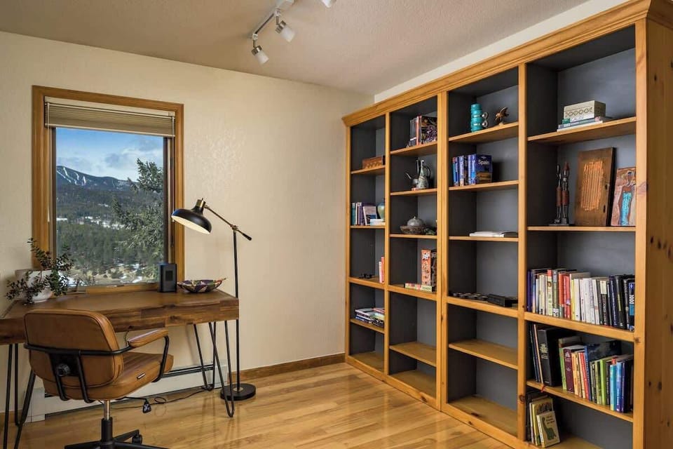 Office nook with incredible views, natural light, and a book & artifact collection from around the world.