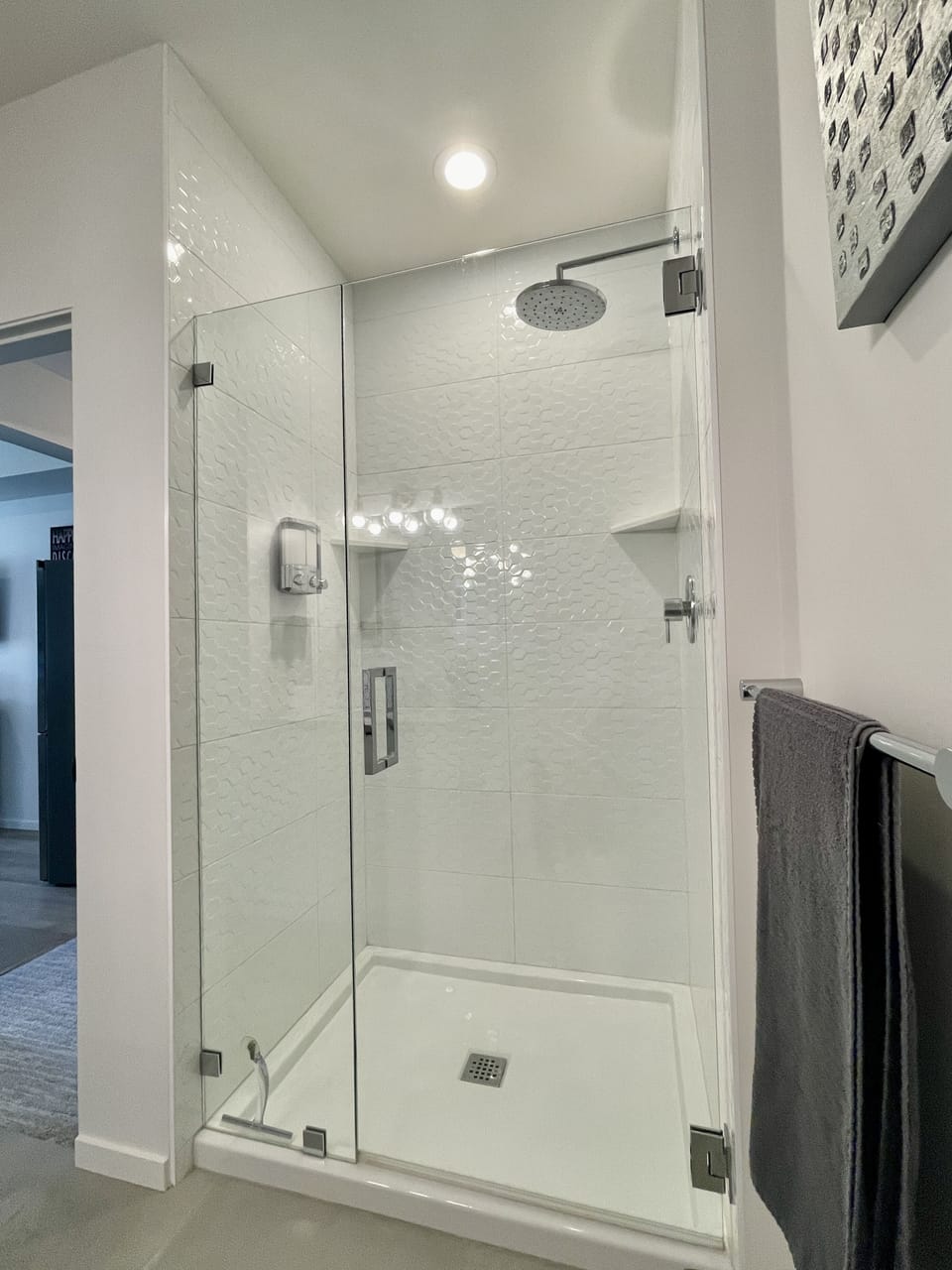 Large shower with Rainfall Shower head
Shampoo, Conditioner & Body Wash on wall 