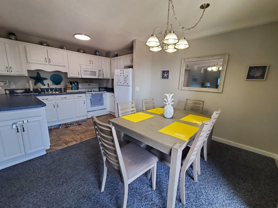 Open area from dining table to kitchen.