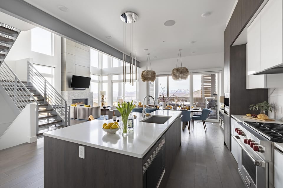 Kitchen features an island with countertop stool seating.