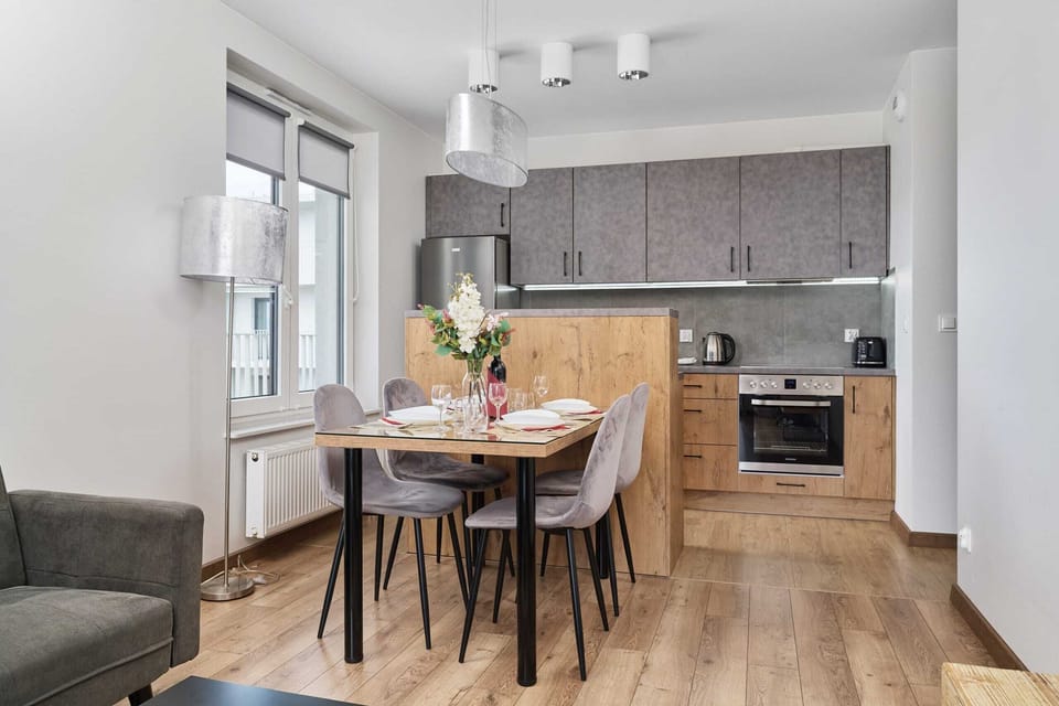 A seating area and fully equipped kitchenette with dining area.