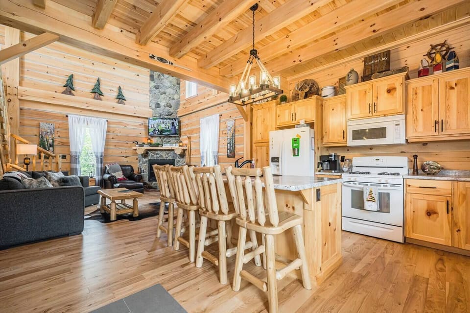 The magnificent open-concept kitchen is stocked with all modern appliances and beautifully decorated, a perfect spot for serving drinks or preparing a meal.