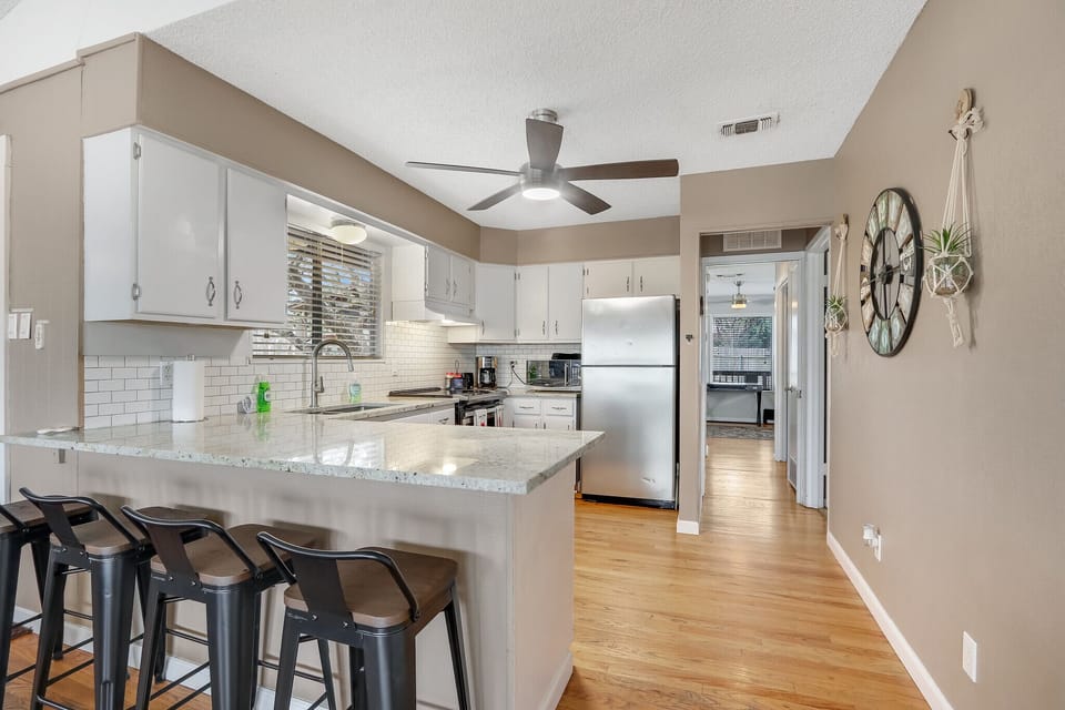View as you enter the kitchen from the living room.  Bedroom 1 can be seen down the hall.