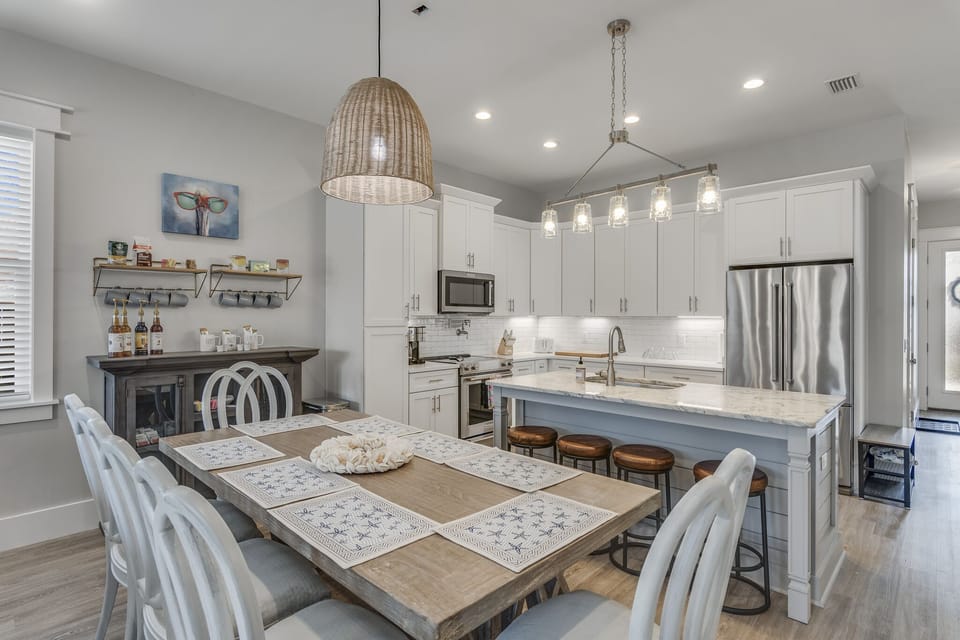 An indoor table and bar island seating as well as outdoor dining. 