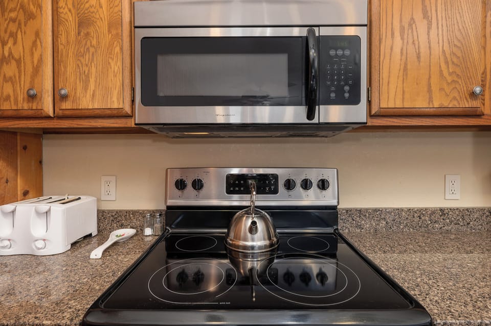 Your fully equipped kitchen features modern appliances including microwave and electric stove, making meal preparation effortless during your stay.
