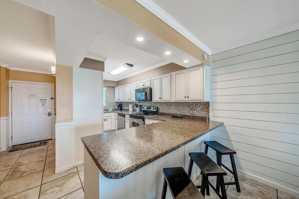 There is a dining table as well as additional breakfast bar seating.