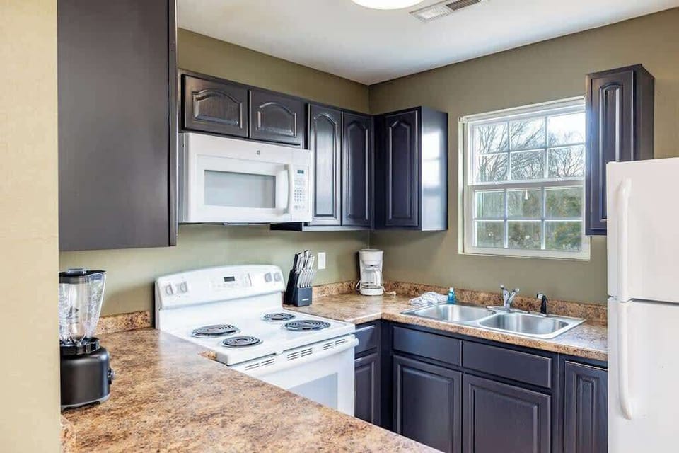 The kitchen is stocked with all the essentials - cutlery, plates, bowls, pots, pans and basic cookware.