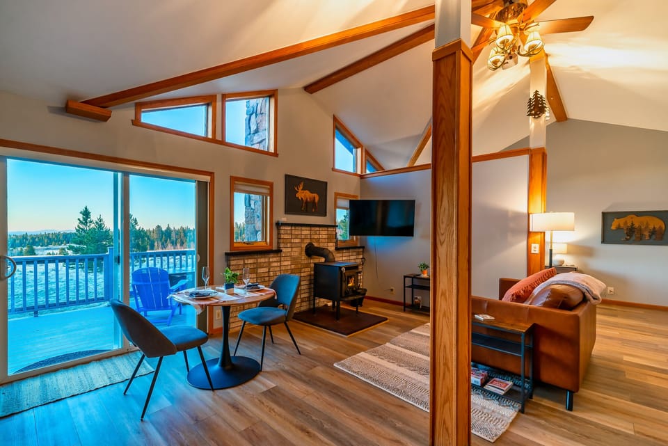 Open living room with 50" smart TV and wood burning stove