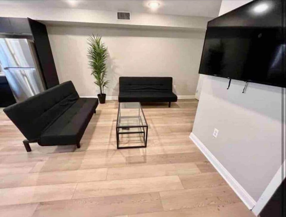 Cozy space featuring two comfy futon sofas and a 55-inch flat-screen TV! The kitchen boasts a stylish quartz island and a dining table—perfect for meals and gatherings. Enjoy your stay!