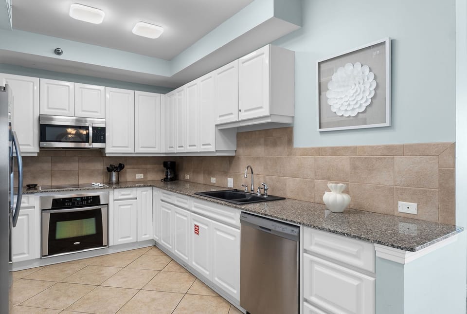 Beach Colony Tower 10C- Your spacious kitchen awaits with stainless steel appliances, granite countertops, and crisp white cabinetry. Everything you need to cook up memorable vacation meals.