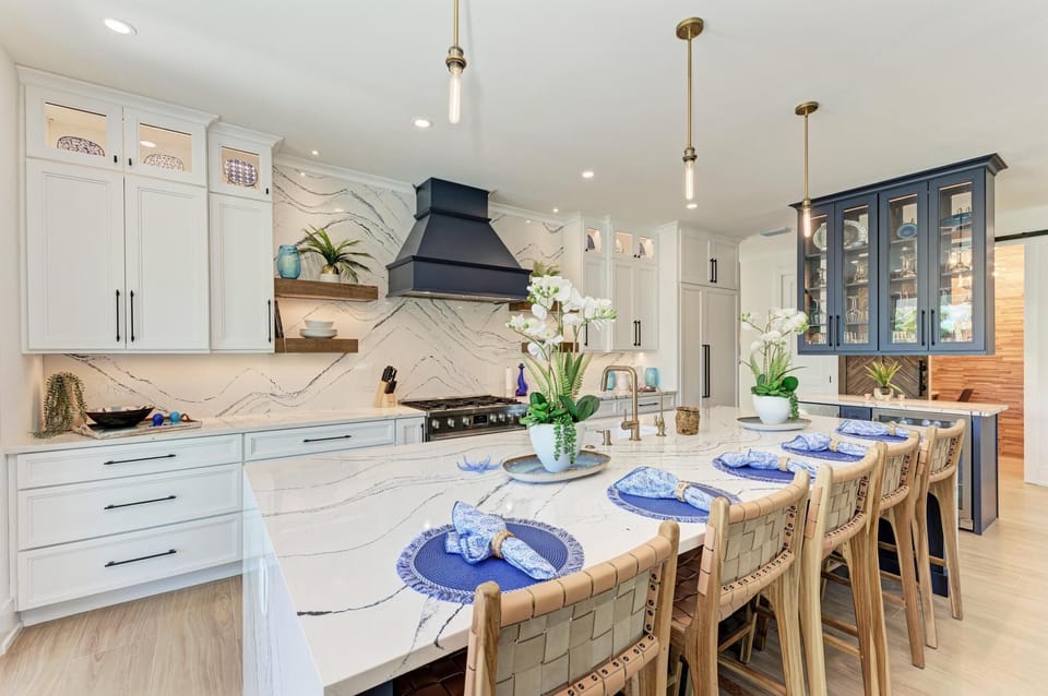 Oversized kitchen island offers additional seating for 5