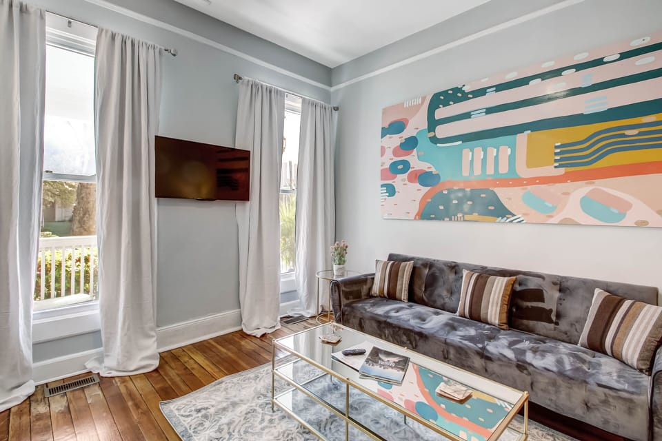 The downstairs living room features a sleeper sofa and a ROKU Smart TV.