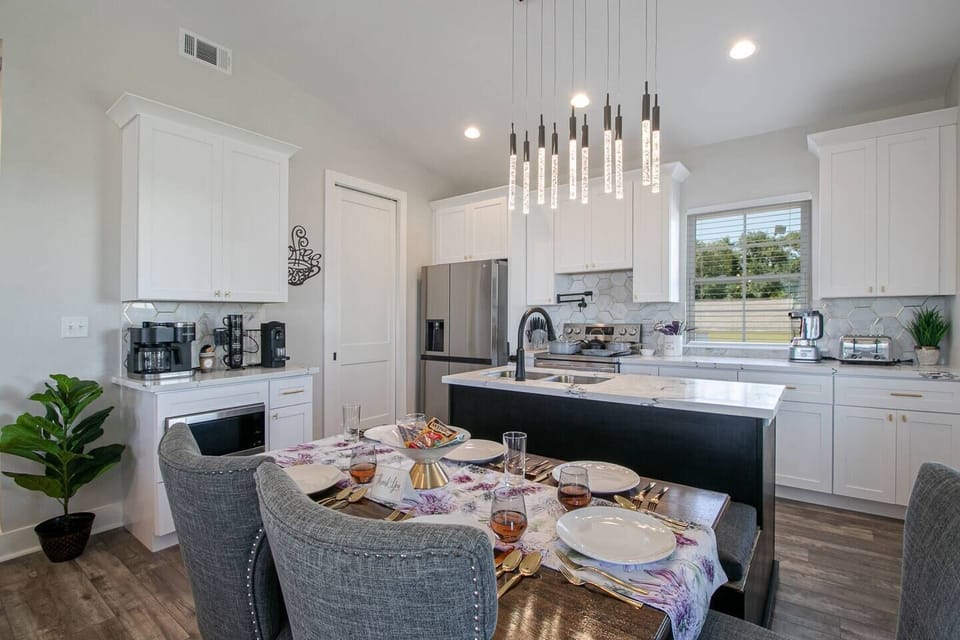 Gather the whole family around the elegant dining table under champagne flute lighting for memorable meals together