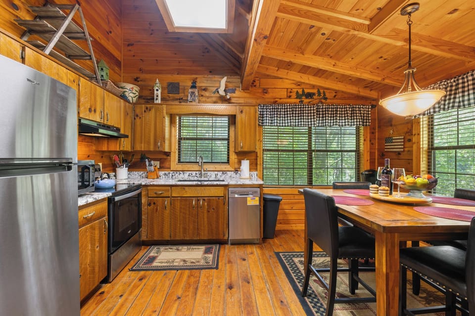 Step into the fully equipped kitchen featuring granite countertops and sleek stainless steel appliances