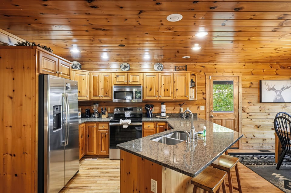 Kitchen with stainless appliances & bar seating for 4