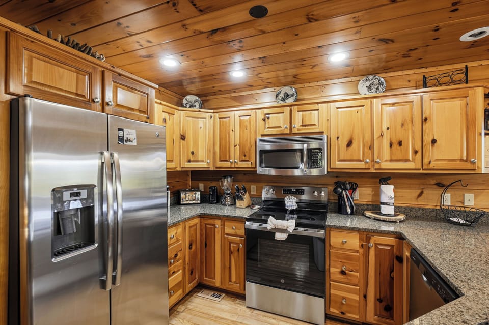 Kitchen with stainless appliances & bar seating for 4
