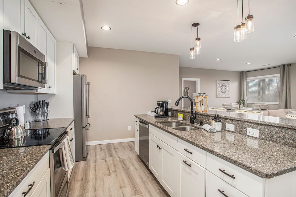 Our beach-themed unit features an open kitchen concept, perfect for modern living. Appliances and ample counter space make meal preparation is a breeze. The kitchen seamlessly blends into the living area, creating a bright and airy space. 