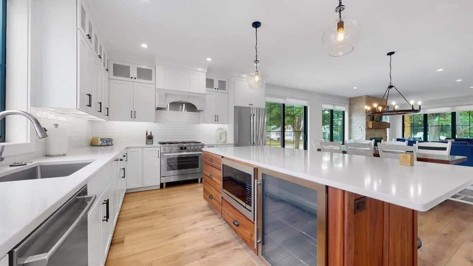 Island with drink fridge and microwave. 36 inch oven/stove combo with vent hood above