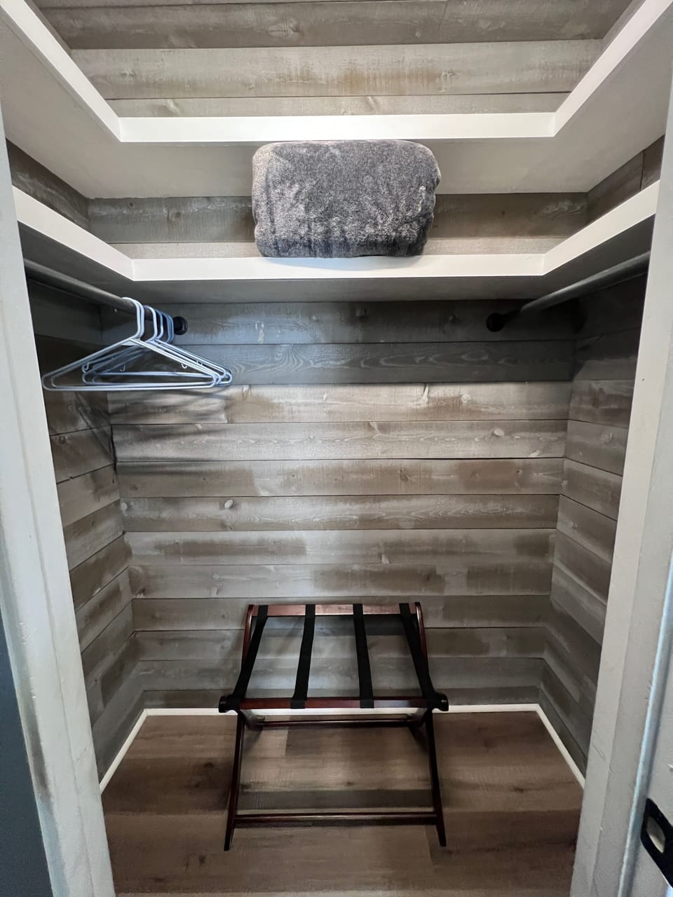 Custom master bedroom closet with natural wood, full-length mirror