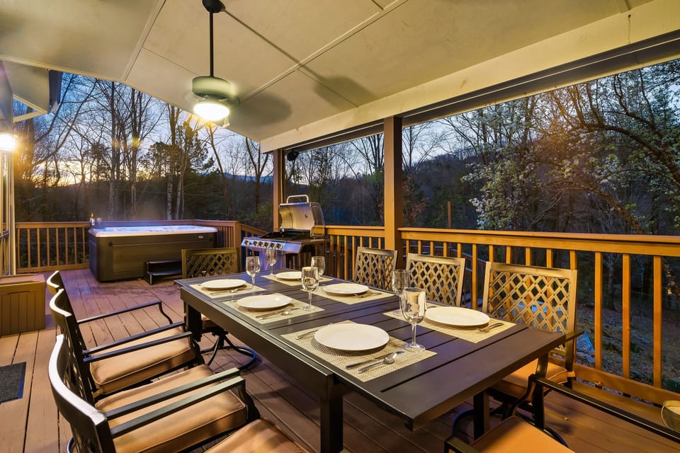Enjoy meals on the covered deck with seating for 8 and a charcoal park grill.