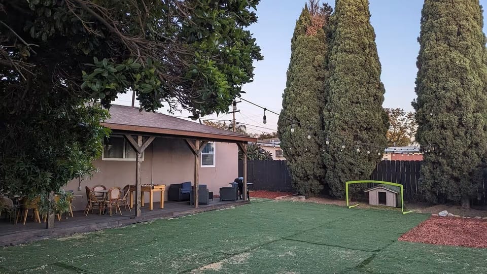 Backyard with deck, grill, roof and patio furniture!